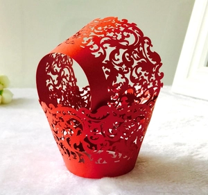 Detailed laser-cut red vine pattern on decorative hollow cupcake wrappers for wedding