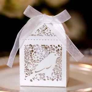 Detail of laser-cut white bird design on pearlescent paper candy box with ribbon