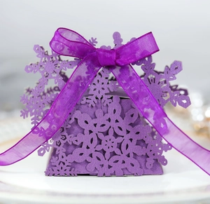 Detailed laser-cut purple snowflake gift box with an elegant matching silk ribbon bow