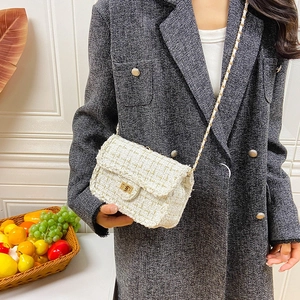 White tweed crossbody square bag with gold chain strap and metallic turn-lock closure
