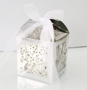 Detailed laser-cut silver star candy box with elegant white organza ribbon bow