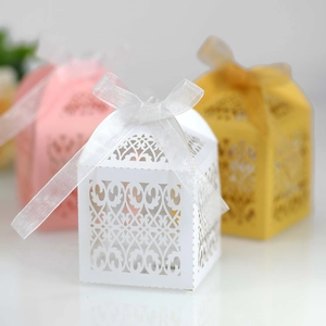 Detailed laser-cut gift boxes with elegant ribbons for wedding favors in three colors