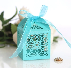Macro detail of laser-cut candy box with elegant tiffany blue ribbon and lace pattern