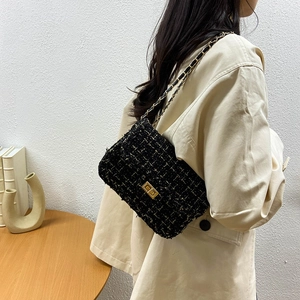 Elegant black tweed chain crossbody bag for women featuring classic gold hardware