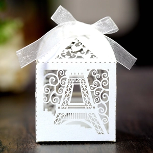 Detail of white laser-cut gift box with Eiffel Tower design and ribbon bow