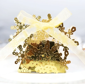 Golden laser-cut snowflake candy box with elegant ribbon for Christmas gifts
