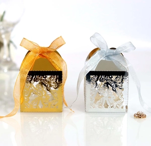 Detail showing gold and silver laser-cut butterfly gift boxes with organza ribbons