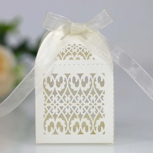 Detailed laser cut patterns on ivory pearl paper gift box with a sheer organza ribbon bow
