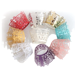 Laser cut Christmas cupcake wrappers with reindeer and snowflake patterns in various colors