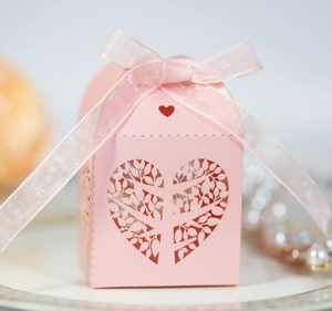 Pink laser-cut heart tree wedding candy box with elegant ribbon bow and pearl accents