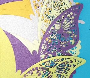 Laser-cut glitter butterfly decorations with intricate hollow patterns for wedding decor