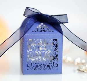 Elegant laser-cut hollow gift box in navy blue with texture and ribbon bow