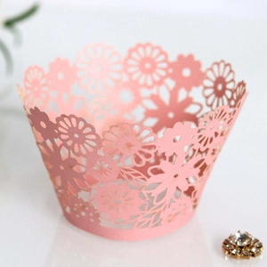 Pink laser-cut floral cupcake wrappers with pearlescent finish for party decoration