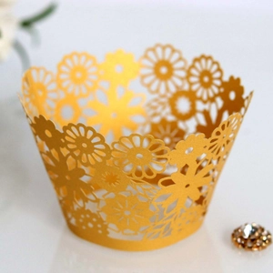 Golden laser cut lace cupcake wrappers with elegant floral patterns for festive parties