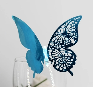 Detailed view of a blue metallic butterfly wall sticker with hollow laser cut design