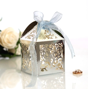 Macro shot of silver hollow gift box with blue ribbon bow for wedding celebrations