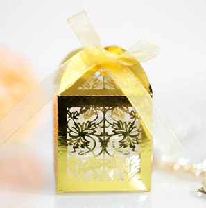 Laser cut hollow wedding candy box with golden mirror finish and yellow organza ribbon bow