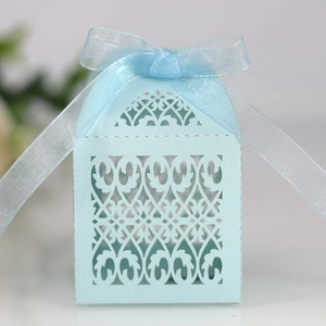Detailed macro view of laser-cut light blue wedding favors box with pearlescent paper finish