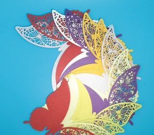 Detail of 3D laser-cut butterflies with intricate lace textures and vibrant colors