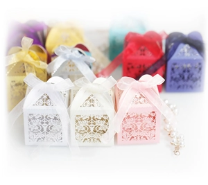 Laser-cut floral wedding favor boxes with organza ribbons in multiple elegant colors
