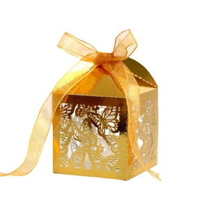 Elegant gold laser-cut candy box with hollow butterfly design and orange organza ribbon