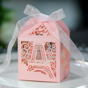 Detail of pink laser-cut Eiffel Tower favor box with pearlescent finish and ribbon