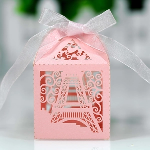 Detailed laser-cut Eiffel Tower pattern on pink candy box with white organza ribbon