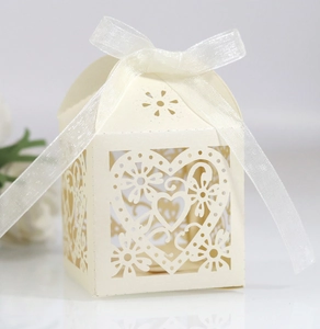 Detailed laser-cut heart and floral patterns on pearlescent cardstock gift box with ribbon