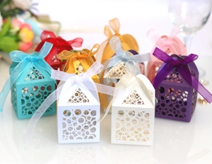 Laser-cut festive party favor boxes in multiple colors with elegant organza ribbons