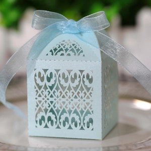 Elegant laser-cut light blue favor box with pearlescent finish and ribbon bow
