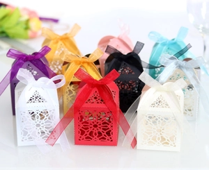 Detailed array of laser-cut candy gift boxes in various colors with silk ribbon bows