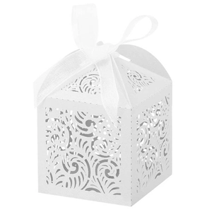 Close-up of white laser-cut floral favor box with a pearl white silk ribbon bow