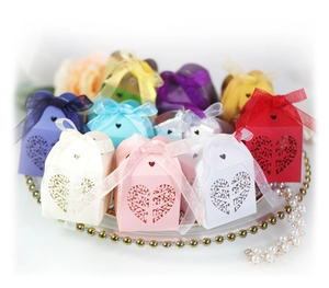 Laser-cut heart tree candy boxes with organza ribbons in various colors for wedding decor