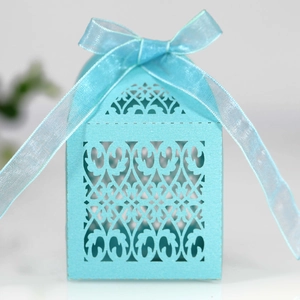 Detail of light blue laser cut wedding favor box with matching sheer organza ribbon
