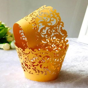 Bright yellow laser-cut cupcake wrappers with elegant lace filigree design on plush fur