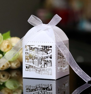 Detailed laser-cut white favor box with Thank You cutout and white organza ribbon bow