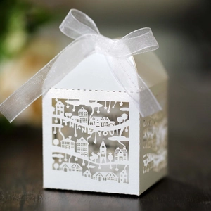 Close-up of white cutout paper gift box with house shape and Thank You text