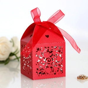 Detailed laser-cut red wedding favor box with elegant floral hollows and ribbon bow