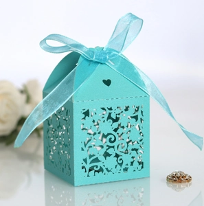 Close-up of light blue laser-cut candy box with elegant ribbon and heart detail