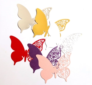 Laser cut gold butterfly place cards with hollow heart patterns for wedding decor