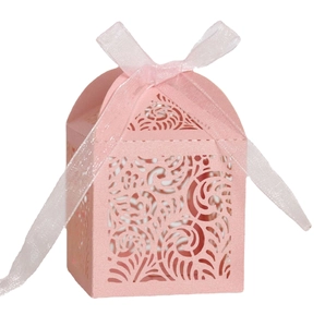 Pink laser-cut wedding favor box with floral patterns and a matching organza ribbon bow