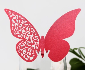 Detail of red glitter butterfly name card for wine glasses with laser cut patterns