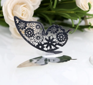Detailed macro view of laser-cut 3D silver hollow butterfly for wedding decor