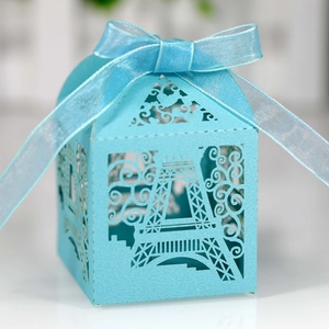 Detail of sky blue Eiffel Tower laser cut favor box with a matching ribbon bow