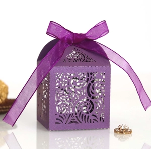 Close-up of purple laser-cut gift box with intricate swirl pattern and organza ribbon