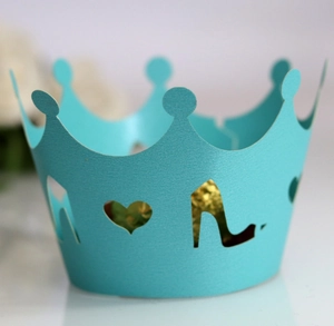 Laser-cut Tiffany blue cupcake wrappers with hollow crown, heart, and high heel patterns