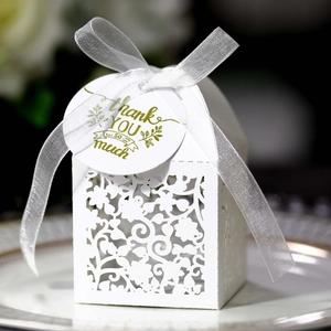Elegant white laser-cut floral favor box with a silk ribbon and Thank You tag