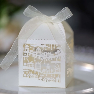 Detail of white laser-cut gift box with THANK YOU text and elegant ribbon bow