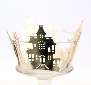 Detailed laser-cut Halloween castle cupcake wrappers in metallic finish on glass