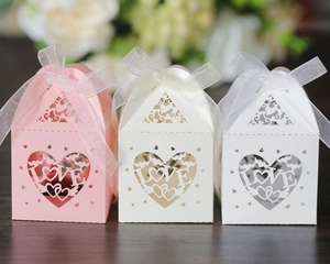 Detailed laser-cut heart and LOVE design on paper candy boxes for weddings and parties